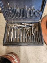 case and metal can full of drillbits