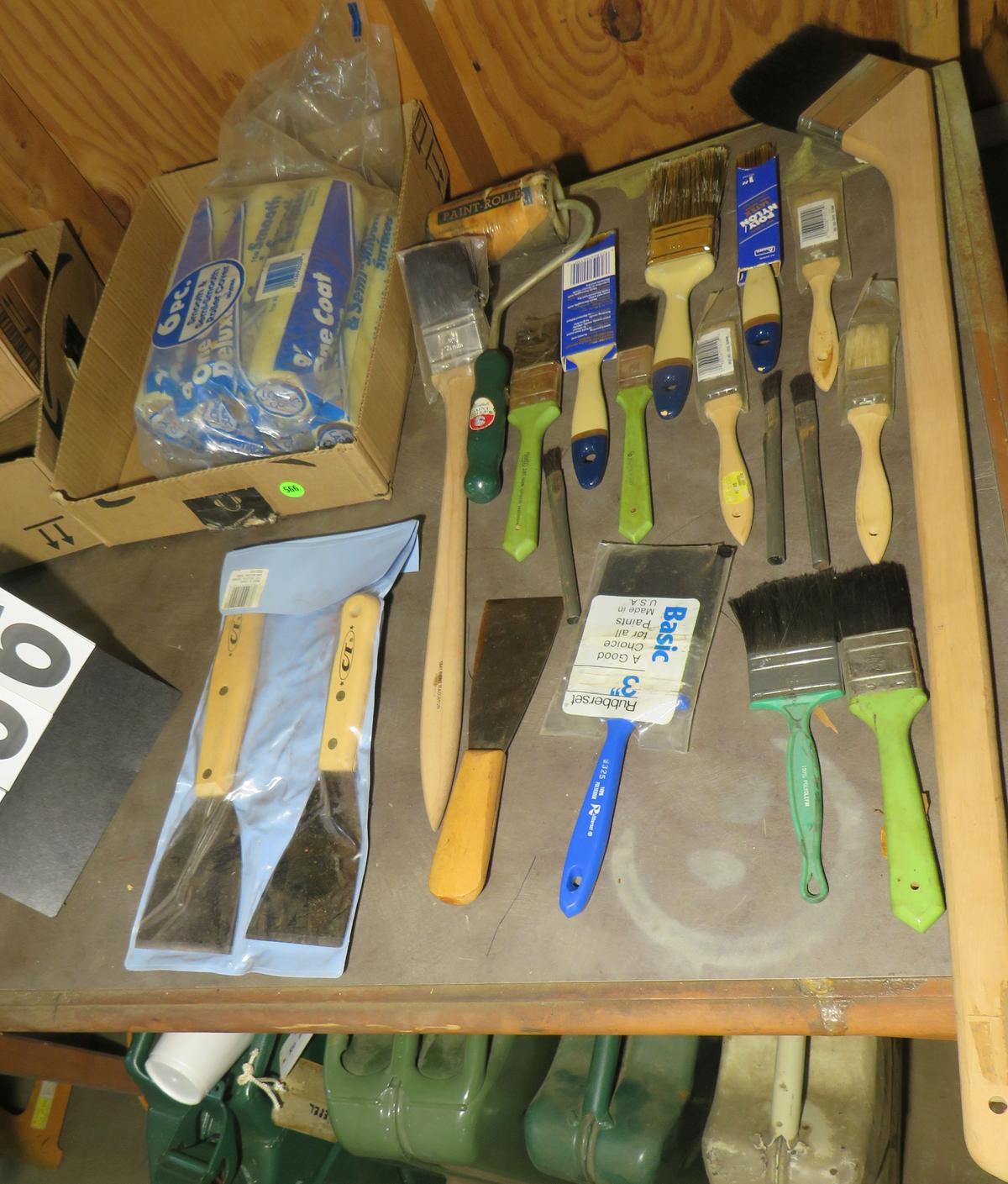 Assorted scrapers and  paint brushes and paint rollers