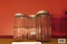 Three antique jars with lids
