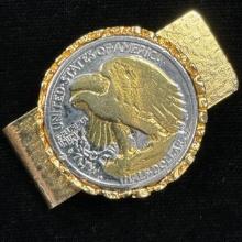 Silver U.S. walking Liberty half dollar with gold highlights mounted on a gold-tone money clip