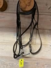 Eggbutt snaffle with leather headstall and braided English reins