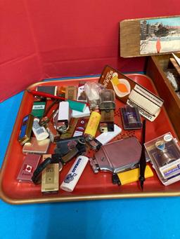 Lot of lighters on a vintage tray, binoculars and fossilized rocks