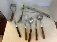 seven CUTCO utensils with wall mount